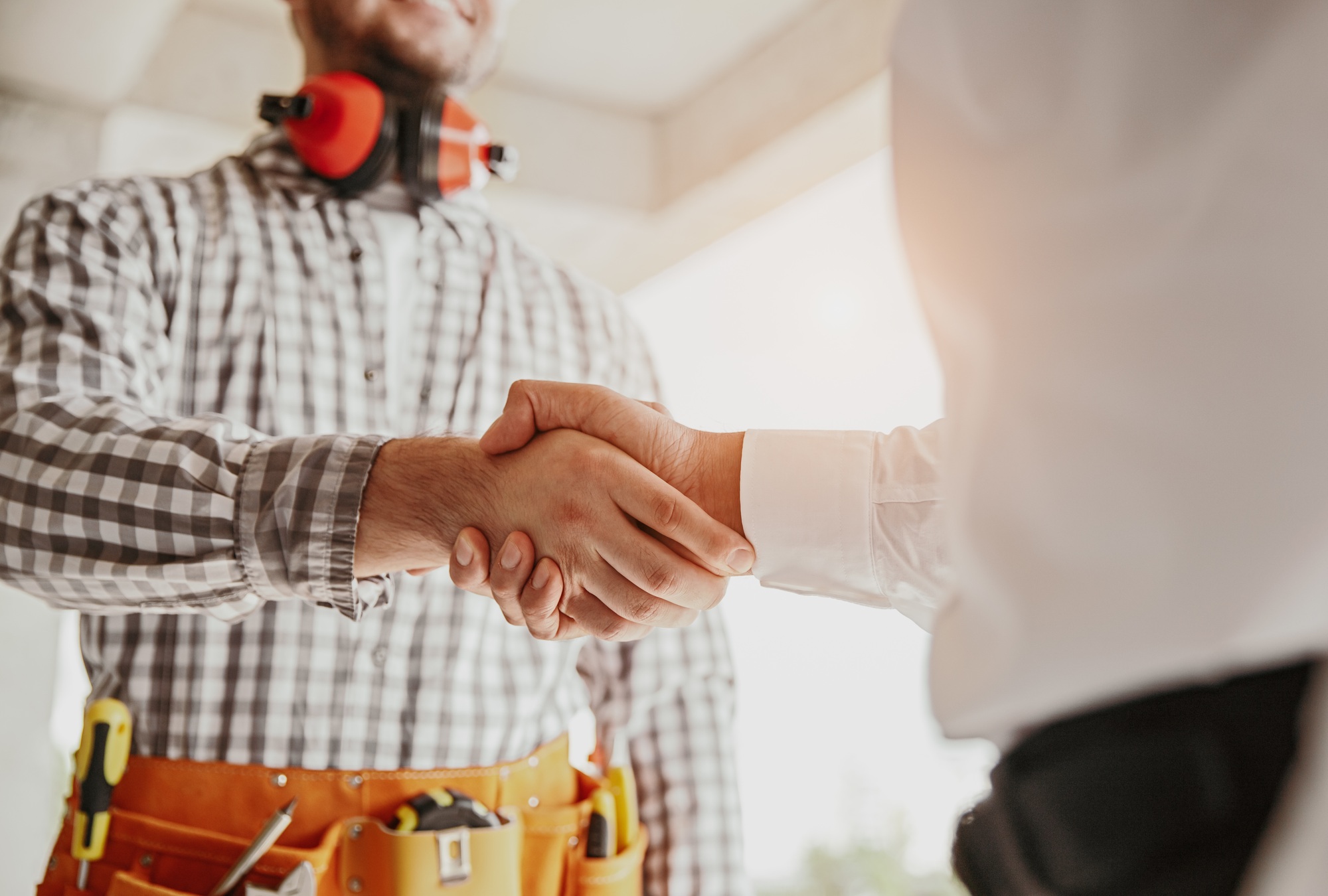 Contractor and builder shaking hands